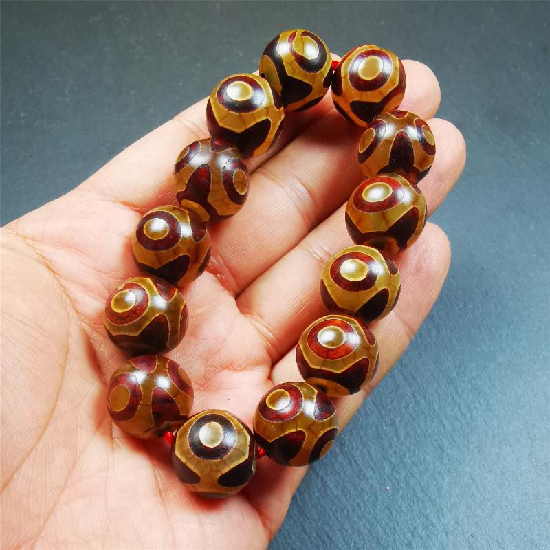 This 3 eyes bracelet was hand-woven by Tibetans,It's made of 3 eyes round dzi beads,brown color,diameter is 0.63", the circumference of bracelet is 7.5". It can be worn not only as a fashionable accessory but also holds cultural and religious significance.