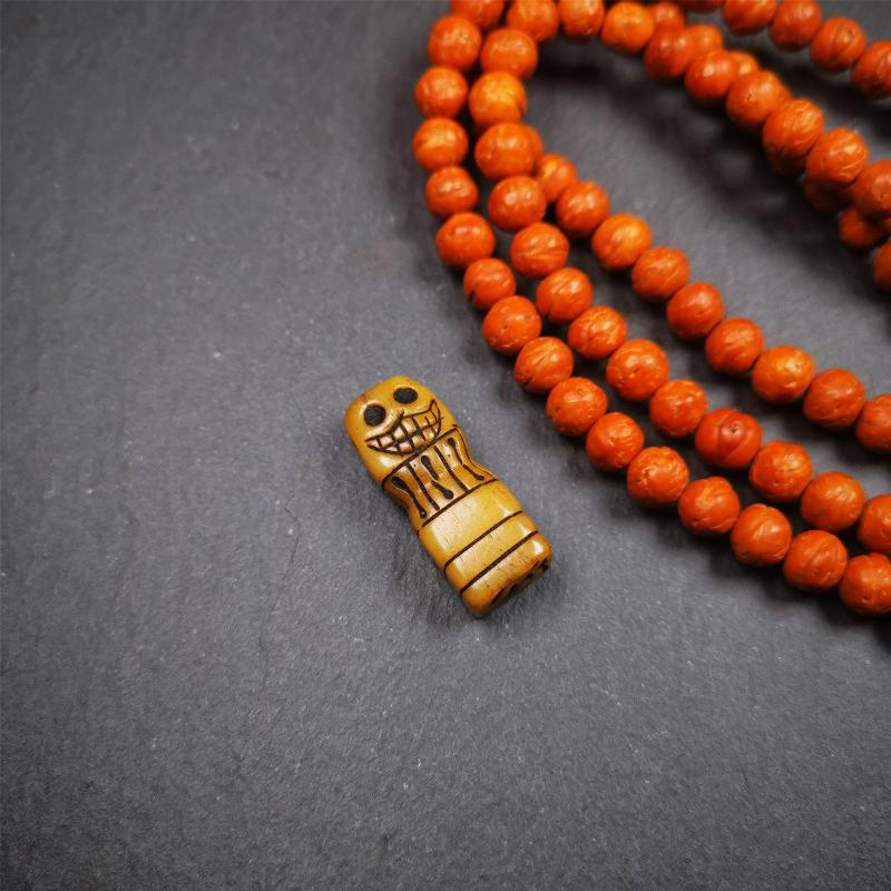 This skull seal amulet was made by Tibetan craftsmen and come from Hepo Town, Baiyu County, the birthplace of the famous Tibetan handicrafts. It's made of yak bone,yellow color,carved skull shape,and OM letter at the bottom,height is inches. You can make it a pendant, keychain.