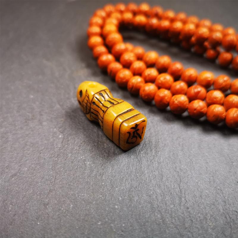 This skull seal amulet was made by Tibetan craftsmen and come from Hepo Town, Baiyu County, the birthplace of the famous Tibetan handicrafts. It's made of yak bone,yellow color,carved skull shape,and OM letter at the bottom,height is inches. You can make it a pendant, keychain.