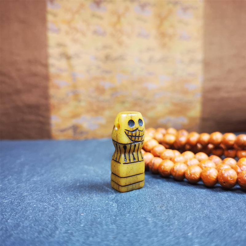 This skull seal amulet was made by Tibetan craftsmen and come from Hepo Town, Baiyu County, the birthplace of the famous Tibetan handicrafts. It's made of yak bone,yellow color,carved skull shape,and OM letter at the bottom,height is inches. You can make it a pendant, keychain.