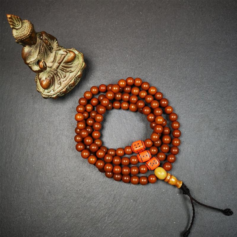 This mala was made by Tibetan craftsmen and come from Hepo Town, Baiyu County, the birthplace of the famous Tibetan handicrafts. It is made of Corypha Linn Seeds, diameter of 8mm / 0.32",circumference is 90cm / 35" ,with 3 dice bead, end of a yak bone guru bead.