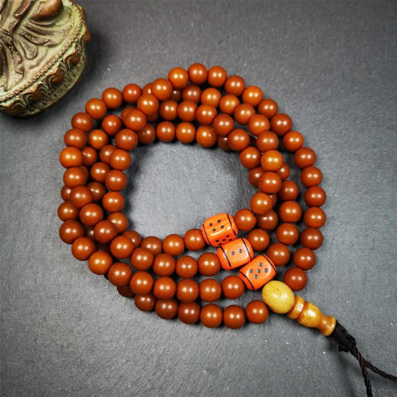 This mala was made by Tibetan craftsmen and come from Hepo Town, Baiyu County, the birthplace of the famous Tibetan handicrafts. It is made of Corypha Linn Seeds, diameter of 8mm / 0.32",circumference is 90cm / 35" ,with 3 dice bead, end of a yak bone guru bead.