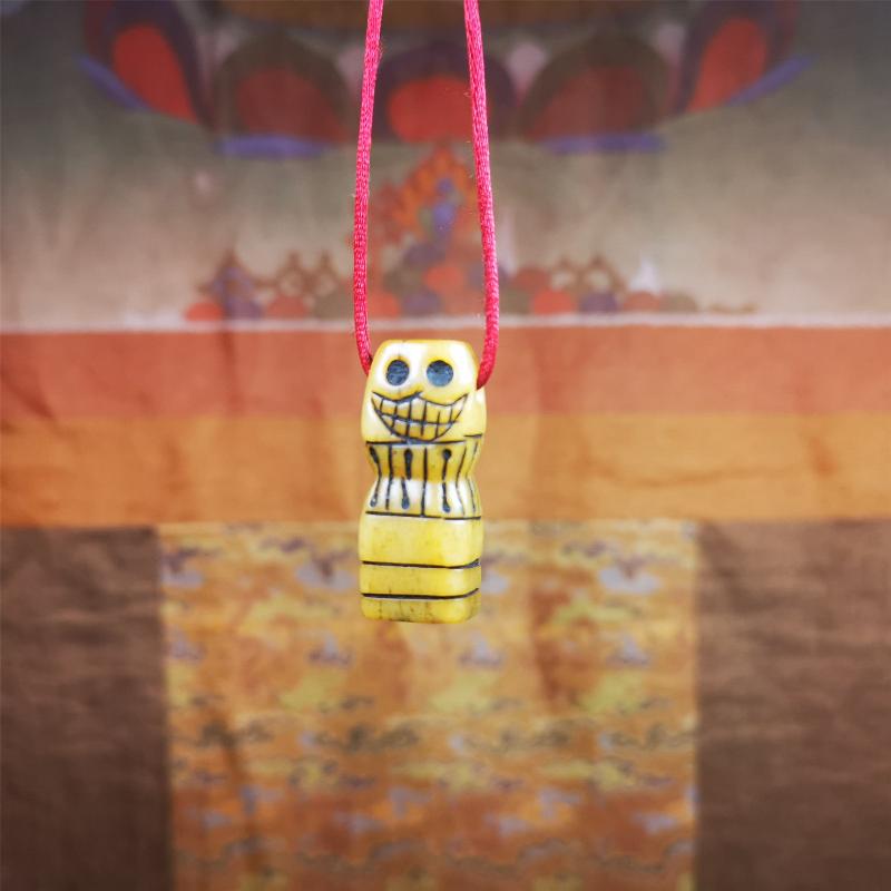 This skull seal amulet was made by Tibetan craftsmen and come from Hepo Town, Baiyu County, the birthplace of the famous Tibetan handicrafts. It's made of yak bone,yellow color,carved skull shape,and OM letter at the bottom,height is inches. You can make it a pendant, keychain.