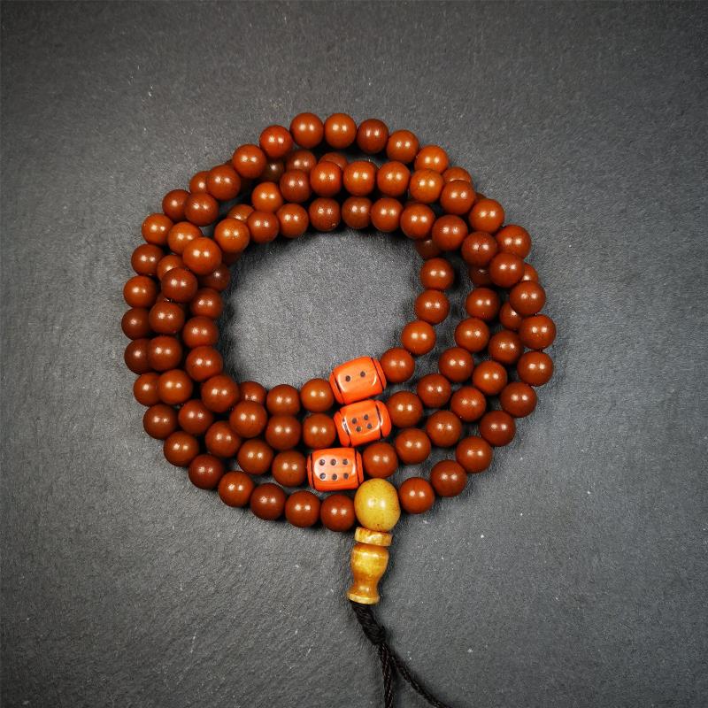 This mala was made by Tibetan craftsmen and come from Hepo Town, Baiyu County, the birthplace of the famous Tibetan handicrafts. It is made of Corypha Linn Seeds, diameter of 8mm / 0.32",circumference is 90cm / 35" ,with 3 dice bead, end of a yak bone guru bead.