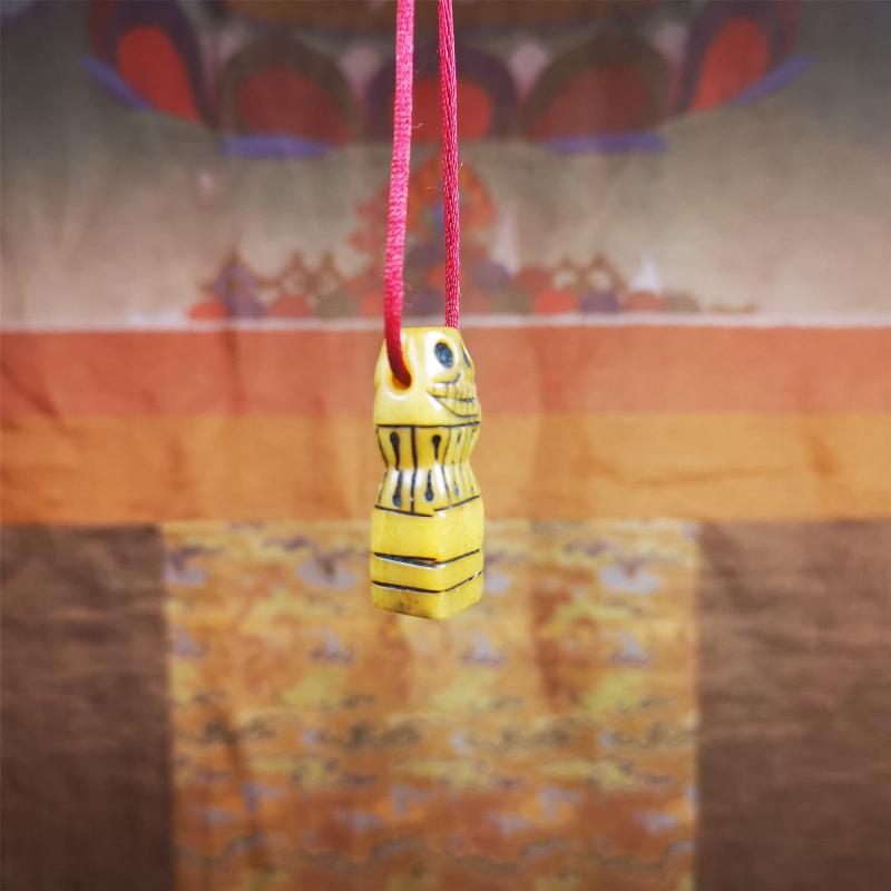 This skull seal amulet was made by Tibetan craftsmen and come from Hepo Town, Baiyu County, the birthplace of the famous Tibetan handicrafts. It's made of yak bone,yellow color,carved skull shape,and OM letter at the bottom,height is inches. You can make it a pendant, keychain.