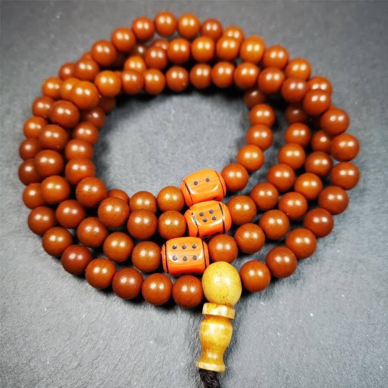 This mala was made by Tibetan craftsmen and come from Hepo Town, Baiyu County, the birthplace of the famous Tibetan handicrafts. It is made of Corypha Linn Seeds, diameter of 8mm / 0.32",circumference is 90cm / 35" ,with 3 dice bead, end of a yak bone guru bead.