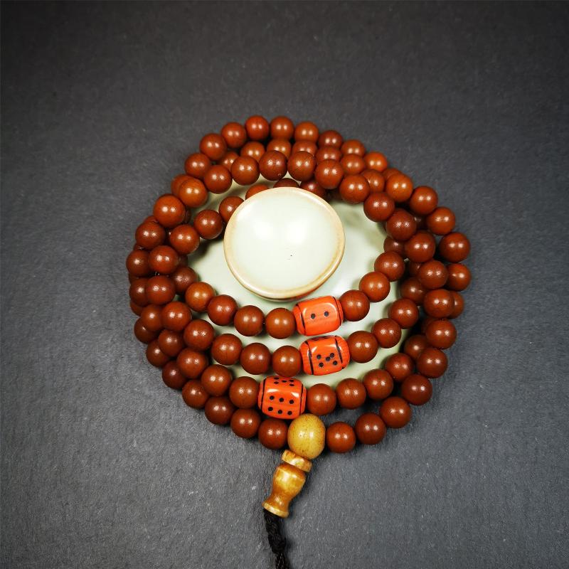 This mala was made by Tibetan craftsmen and come from Hepo Town, Baiyu County, the birthplace of the famous Tibetan handicrafts. It is made of Corypha Linn Seeds, diameter of 8mm / 0.32",circumference is 90cm / 35" ,with 3 dice bead, end of a yak bone guru bead.