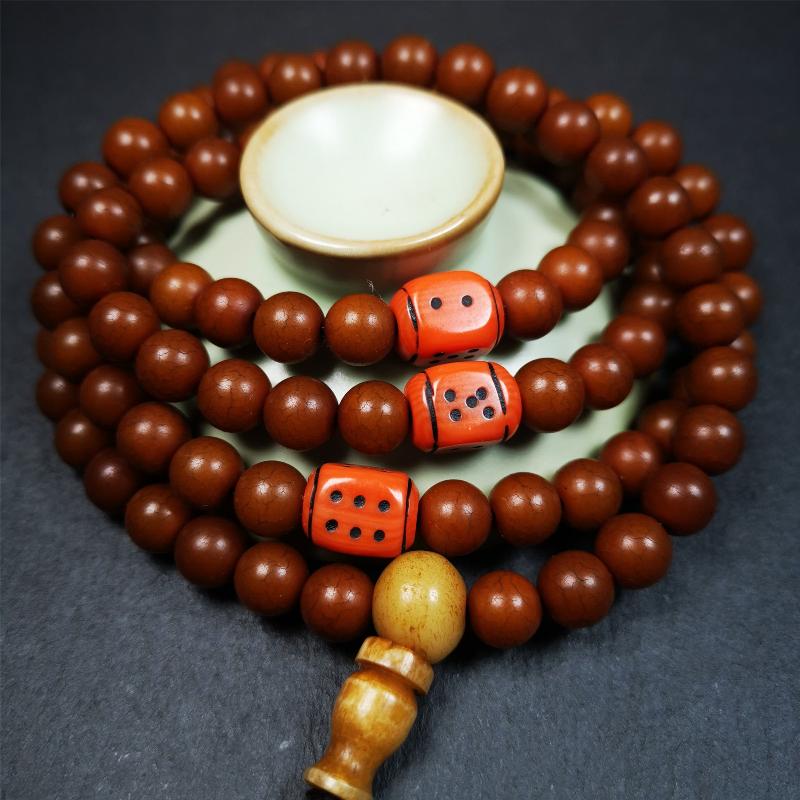 This mala was made by Tibetan craftsmen and come from Hepo Town, Baiyu County, the birthplace of the famous Tibetan handicrafts. It is made of Corypha Linn Seeds, diameter of 8mm / 0.32",circumference is 90cm / 35" ,with 3 dice bead, end of a yak bone guru bead.