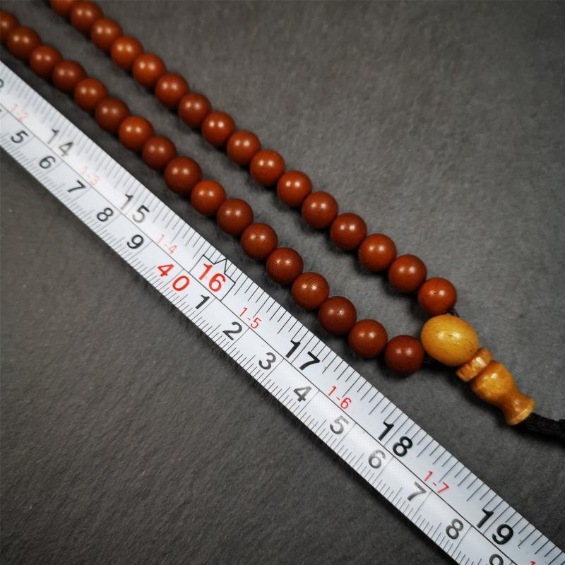 This mala was made by Tibetan craftsmen and come from Hepo Town, Baiyu County, the birthplace of the famous Tibetan handicrafts. It is made of Corypha Linn Seeds, diameter of 8mm / 0.32",circumference is 90cm / 35" ,with 3 dice bead, end of a yak bone guru bead.