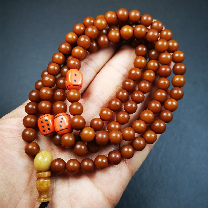 This mala was made by Tibetan craftsmen and come from Hepo Town, Baiyu County, the birthplace of the famous Tibetan handicrafts. It is made of Corypha Linn Seeds, diameter of 8mm / 0.32",circumference is 90cm / 35" ,with 3 dice bead, end of a yak bone guru bead.