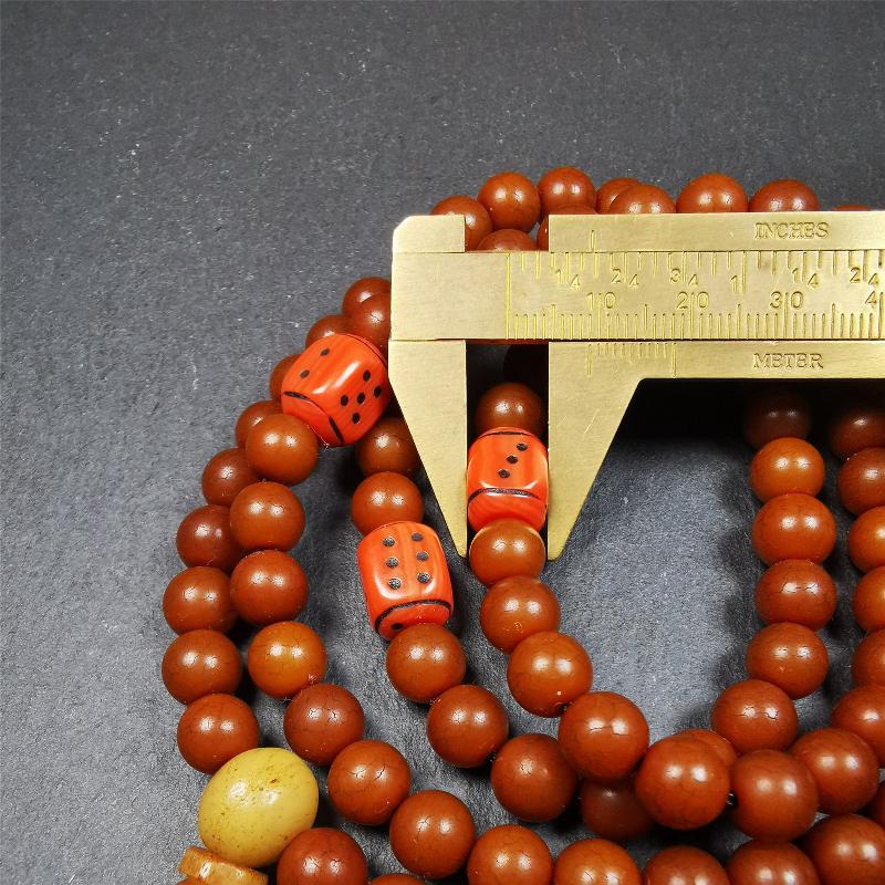 This mala was made by Tibetan craftsmen and come from Hepo Town, Baiyu County, the birthplace of the famous Tibetan handicrafts. It is made of Corypha Linn Seeds, diameter of 8mm / 0.32",circumference is 90cm / 35" ,with 3 dice bead, end of a yak bone guru bead.