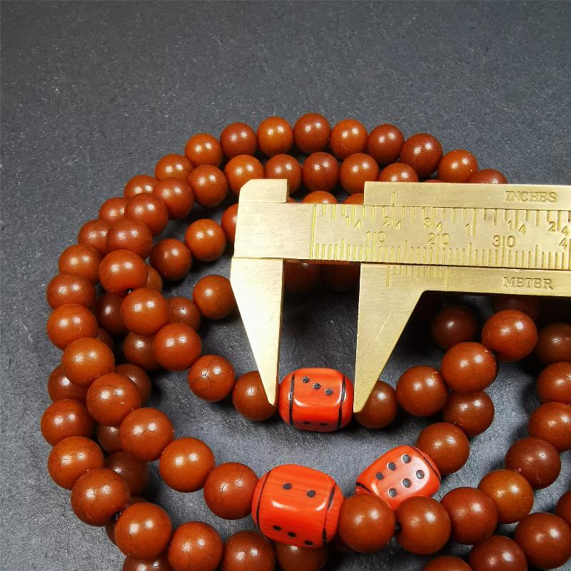 This mala was made by Tibetan craftsmen and come from Hepo Town, Baiyu County, the birthplace of the famous Tibetan handicrafts. It is made of Corypha Linn Seeds, diameter of 8mm / 0.32",circumference is 90cm / 35" ,with 3 dice bead, end of a yak bone guru bead.