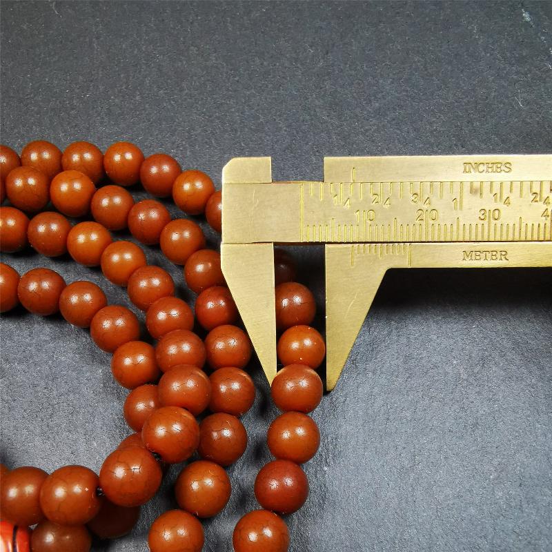 This mala was made by Tibetan craftsmen and come from Hepo Town, Baiyu County, the birthplace of the famous Tibetan handicrafts. It is made of Corypha Linn Seeds, diameter of 8mm / 0.32",circumference is 90cm / 35" ,with 3 dice bead, end of a yak bone guru bead.