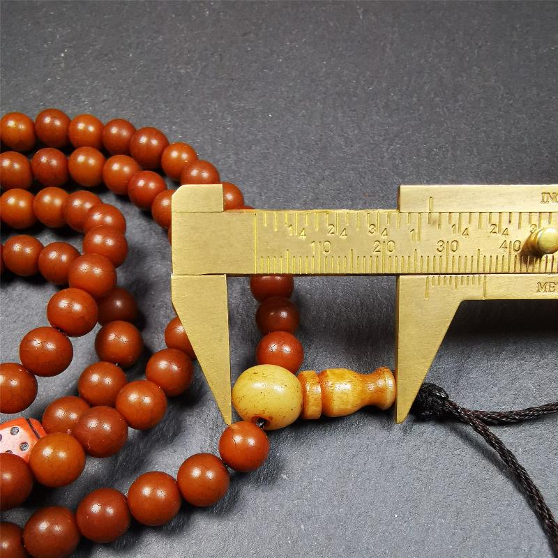 This mala was made by Tibetan craftsmen and come from Hepo Town, Baiyu County, the birthplace of the famous Tibetan handicrafts. It is made of Corypha Linn Seeds, diameter of 8mm / 0.32",circumference is 90cm / 35" ,with 3 dice bead, end of a yak bone guru bead.