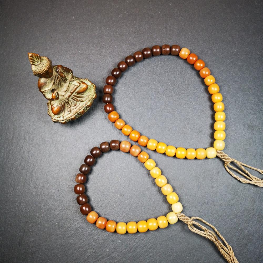This mala was made by Tibetan craftsmen and come from Hepo Town, Baiyu County, the birthplace of the famous Tibetan handicrafts. It is made of Corypha Linn Seeds, diameter of 10mm / 0.4",gradient color, designed as a couple set,the large size for men, small size for women.