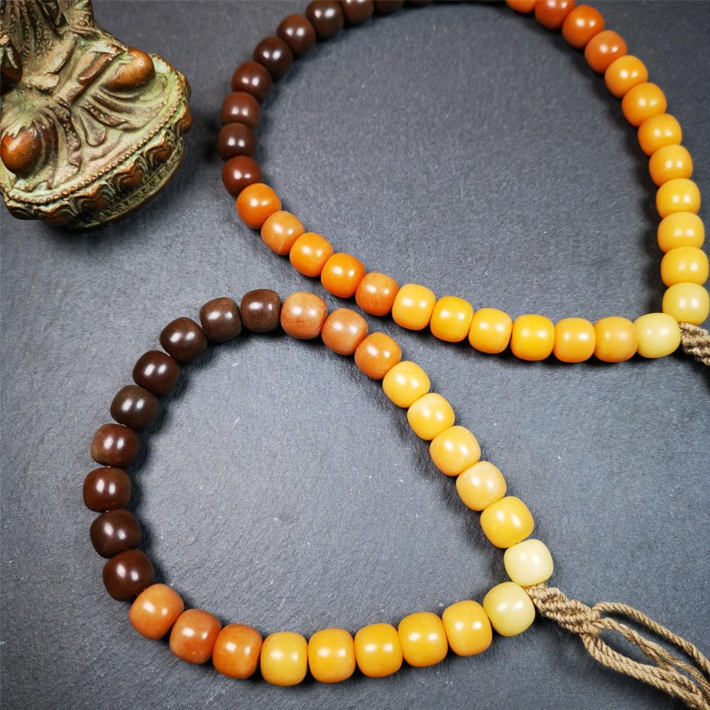 This mala was made by Tibetan craftsmen and come from Hepo Town, Baiyu County, the birthplace of the famous Tibetan handicrafts. It is made of Corypha Linn Seeds, diameter of 10mm / 0.4",gradient color, designed as a couple set,the large size for men, small size for women.