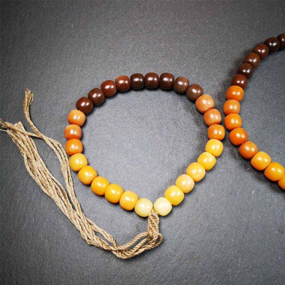 This mala was made by Tibetan craftsmen and come from Hepo Town, Baiyu County, the birthplace of the famous Tibetan handicrafts. It is made of Corypha Linn Seeds, diameter of 10mm / 0.4",gradient color, designed as a couple set,the large size for men, small size for women.