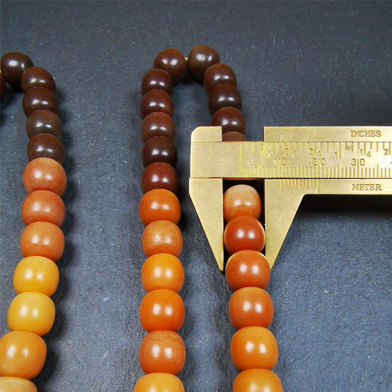 This mala was made by Tibetan craftsmen and come from Hepo Town, Baiyu County, the birthplace of the famous Tibetan handicrafts. It is made of Corypha Linn Seeds, diameter of 10mm / 0.4",gradient color, designed as a couple set,the large size for men, small size for women.