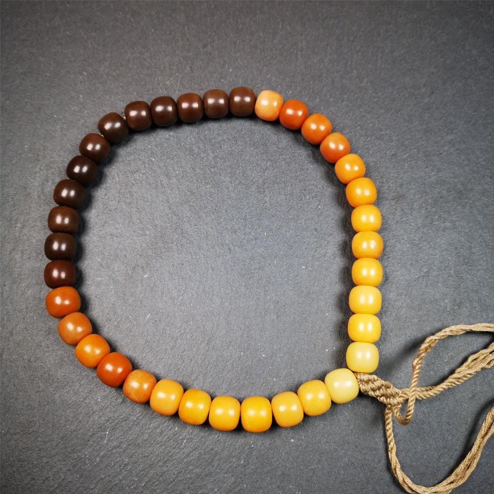 This mala was made by Tibetan craftsmen and come from Hepo Town, Baiyu County, the birthplace of the famous Tibetan handicrafts. It is made of Corypha Linn Seeds, diameter of 10mm / 0.4",gradient color, designed as a couple set,the large size for men, small size for women.