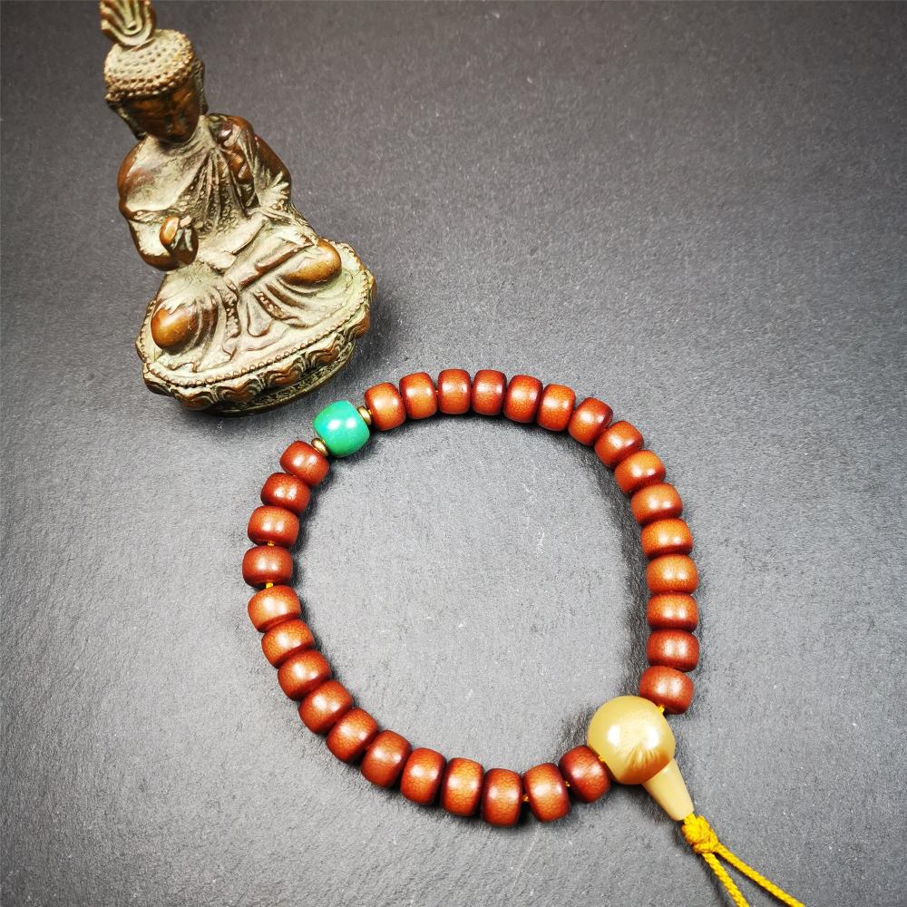 This bracelet mala was made by Tibetan craftsmen and come from Hepo Town, Baiyu County, the birthplace of the famous Tibetan handicrafts. It is made of Corypha Linn Seeds, diameter of 10mm / 0.4",circumference is 26cm / 10" ,with turquoise spacer bead, end of a yak horn guru bead.