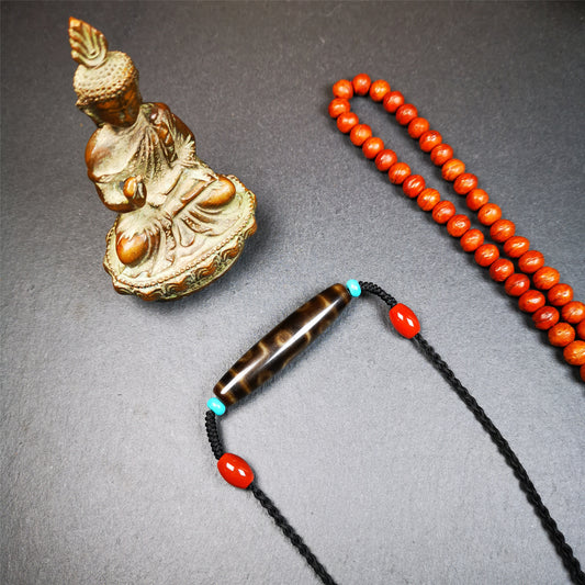 This necklace was hand-woven by Tibetans from Baiyu County, the main bead is a brown color 9 eyes dzi, paired with 2 turquoise beads and 2 red agate beads,about 30 years old. The length of the necklace can be adjusted, the maximum circumference is about 60cm.