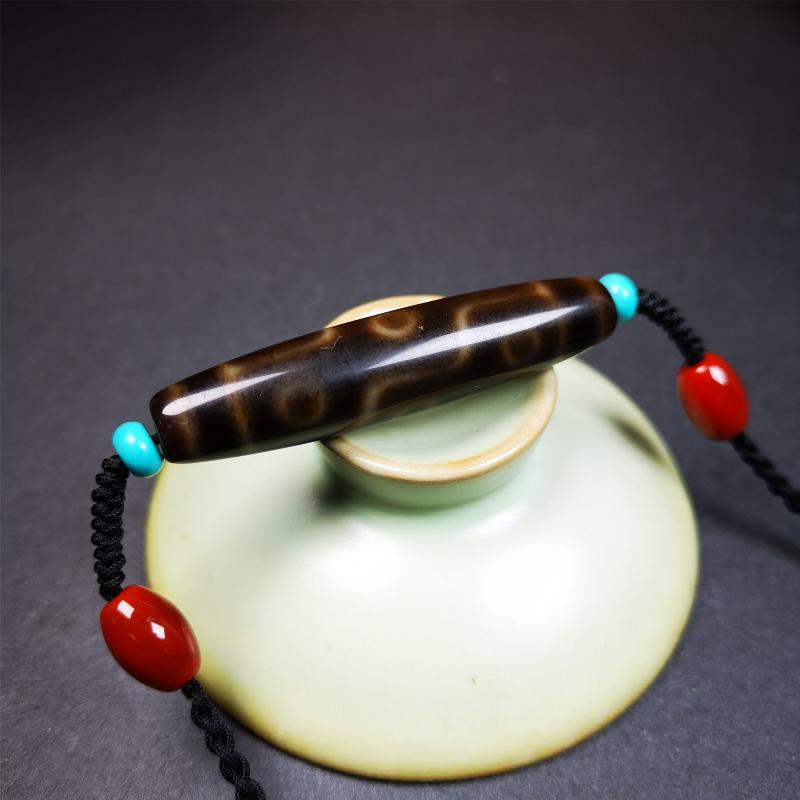 This necklace was hand-woven by Tibetans from Baiyu County, the main bead is a brown color 9 eyes dzi, paired with 2 turquoise beads and 2 red agate beads,about 30 years old. The length of the necklace can be adjusted, the maximum circumference is about 60cm.