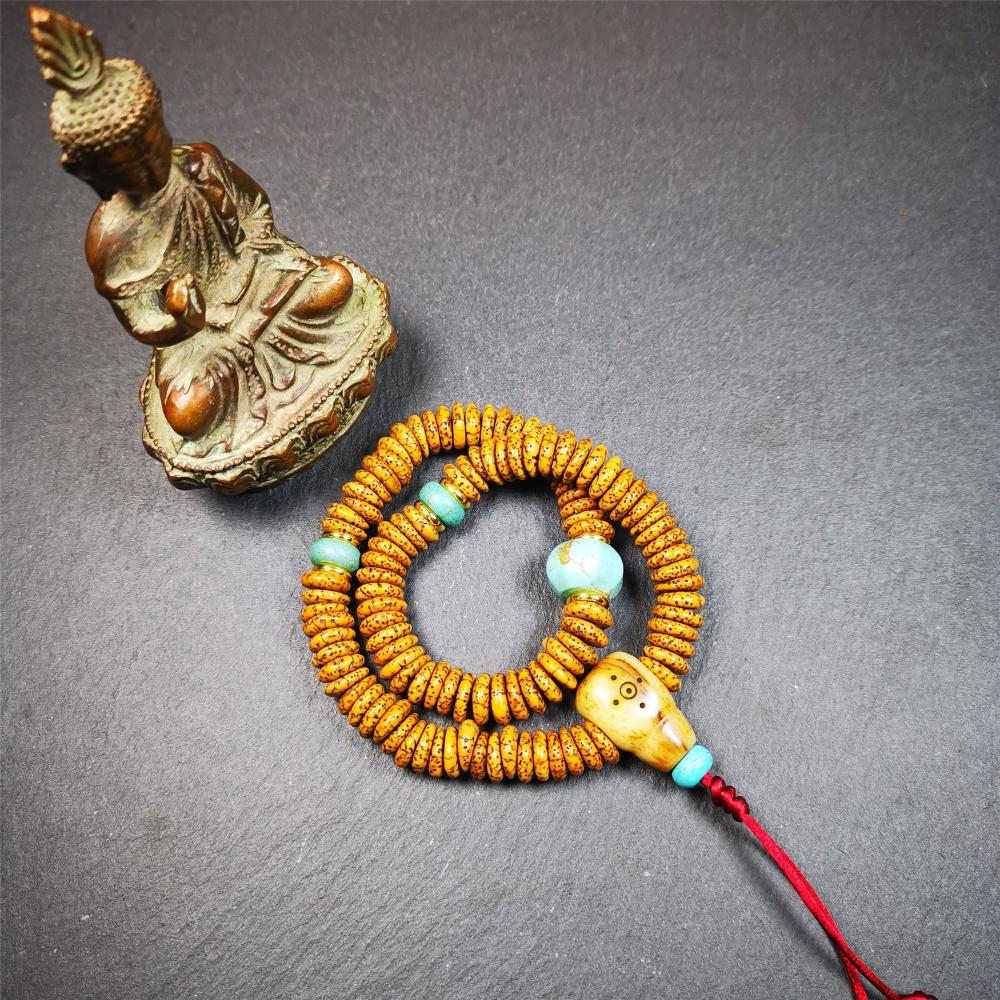 This flat lotus seed mala was collected from Gerze county,about 30 years old,hold and blessed by a lama. It is composed of 108 bodhi seed beads, flat cut shape,brown color,with 4 turquoise beads and 1 yak bone guru bead.