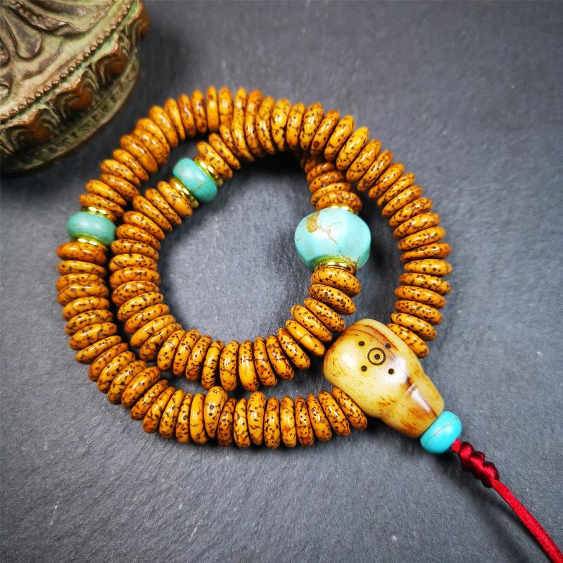 This flat lotus seed mala was collected from Gerze county,about 30 years old,hold and blessed by a lama. It is composed of 108 bodhi seed beads, flat cut shape,brown color,with 4 turquoise beads and 1 yak bone guru bead.