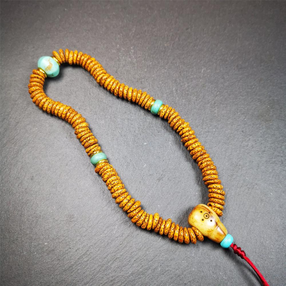 This flat lotus seed mala was collected from Gerze county,about 30 years old,hold and blessed by a lama. It is composed of 108 bodhi seed beads, flat cut shape,brown color,with 4 turquoise beads and 1 yak bone guru bead.