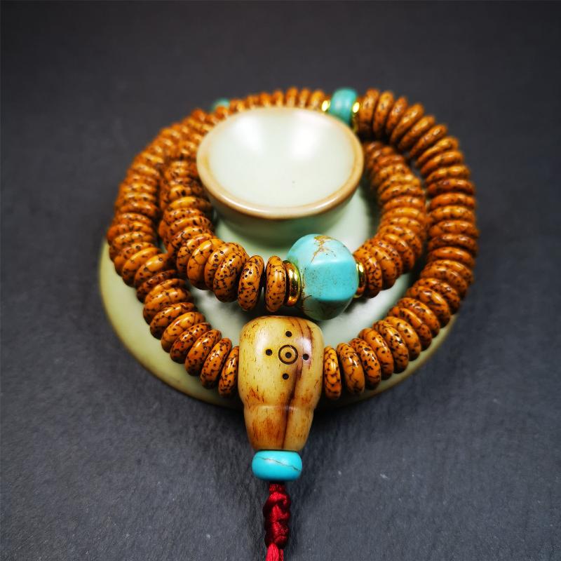 This flat lotus seed mala was collected from Gerze county,about 30 years old,hold and blessed by a lama. It is composed of 108 bodhi seed beads, flat cut shape,brown color,with 4 turquoise beads and 1 yak bone guru bead.