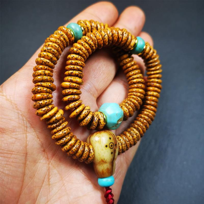 This flat lotus seed mala was collected from Gerze county,about 30 years old,hold and blessed by a lama. It is composed of 108 bodhi seed beads, flat cut shape,brown color,with 4 turquoise beads and 1 yak bone guru bead.
