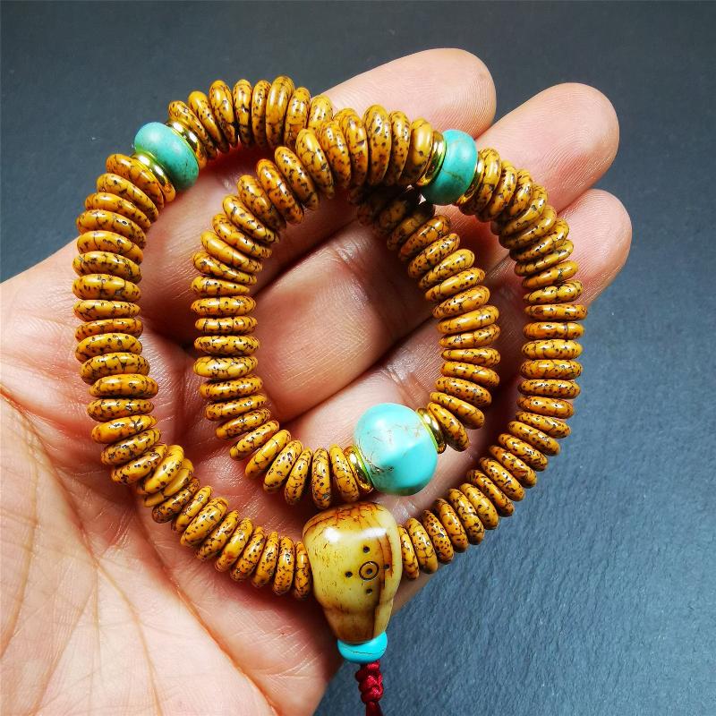 This flat lotus seed mala was collected from Gerze county,about 30 years old,hold and blessed by a lama. It is composed of 108 bodhi seed beads, flat cut shape,brown color,with 4 turquoise beads and 1 yak bone guru bead.