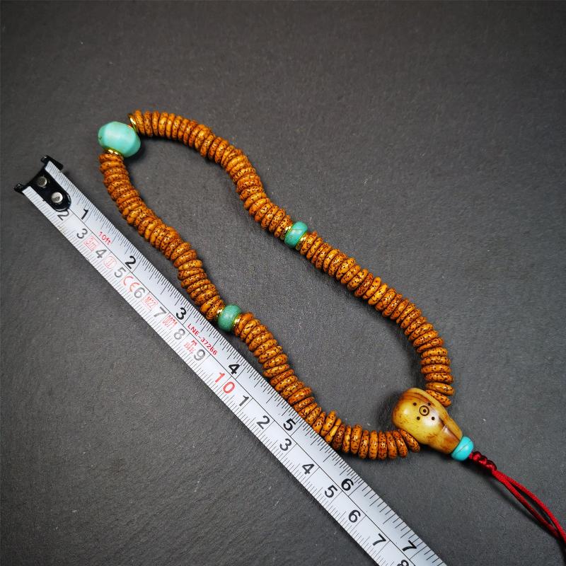 This flat lotus seed mala was collected from Gerze county,about 30 years old,hold and blessed by a lama. It is composed of 108 bodhi seed beads, flat cut shape,brown color,with 4 turquoise beads and 1 yak bone guru bead.