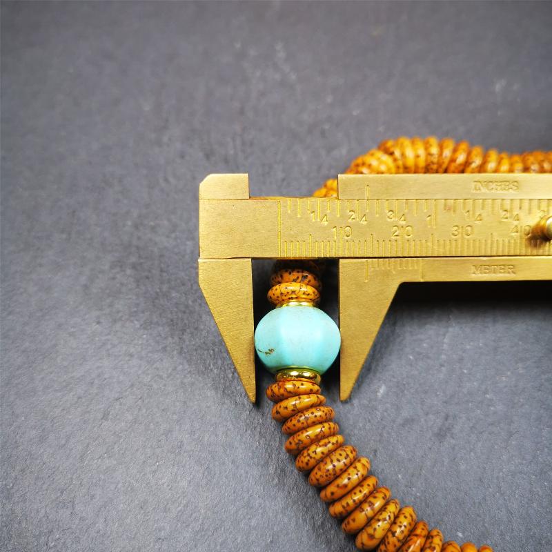 This flat lotus seed mala was collected from Gerze county,about 30 years old,hold and blessed by a lama. It is composed of 108 bodhi seed beads, flat cut shape,brown color,with 4 turquoise beads and 1 yak bone guru bead.