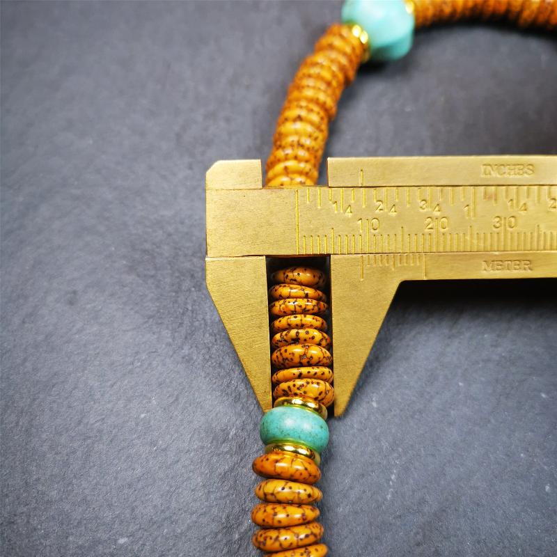 This flat lotus seed mala was collected from Gerze county,about 30 years old,hold and blessed by a lama. It is composed of 108 bodhi seed beads, flat cut shape,brown color,with 4 turquoise beads and 1 yak bone guru bead.