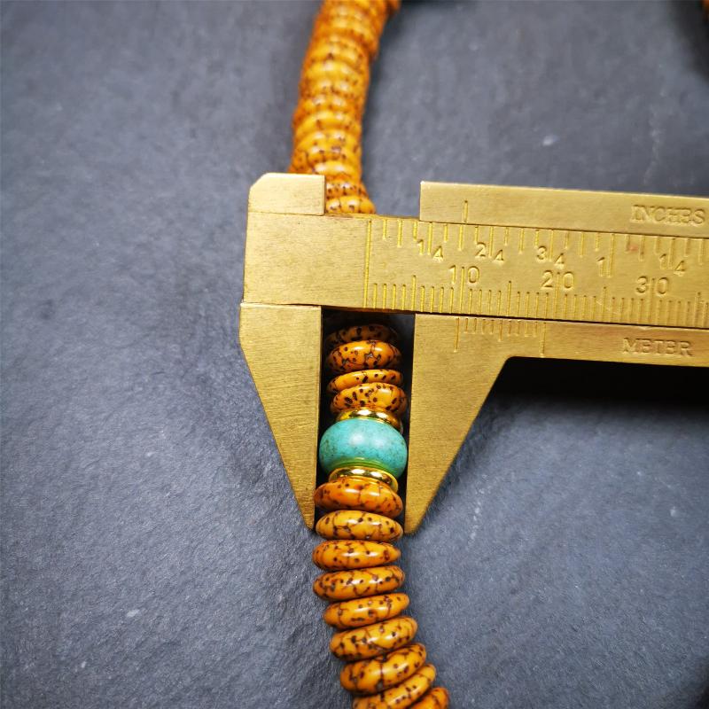 This flat lotus seed mala was collected from Gerze county,about 30 years old,hold and blessed by a lama. It is composed of 108 bodhi seed beads, flat cut shape,brown color,with 4 turquoise beads and 1 yak bone guru bead.