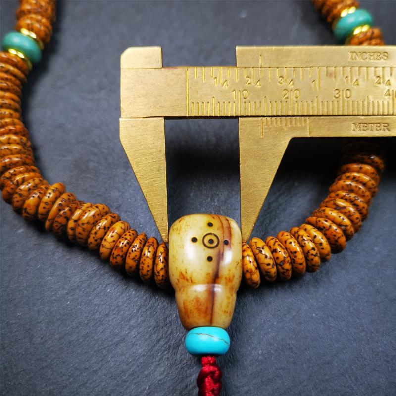 This flat lotus seed mala was collected from Gerze county,about 30 years old,hold and blessed by a lama. It is composed of 108 bodhi seed beads, flat cut shape,brown color,with 4 turquoise beads and 1 yak bone guru bead.