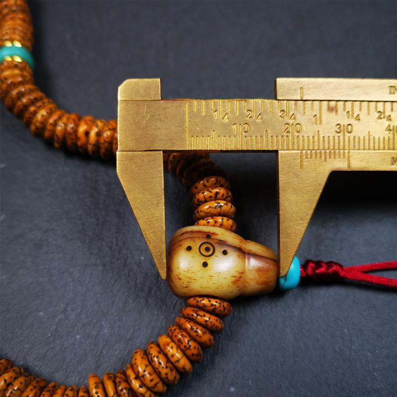 This flat lotus seed mala was collected from Gerze county,about 30 years old,hold and blessed by a lama. It is composed of 108 bodhi seed beads, flat cut shape,brown color,with 4 turquoise beads and 1 yak bone guru bead.