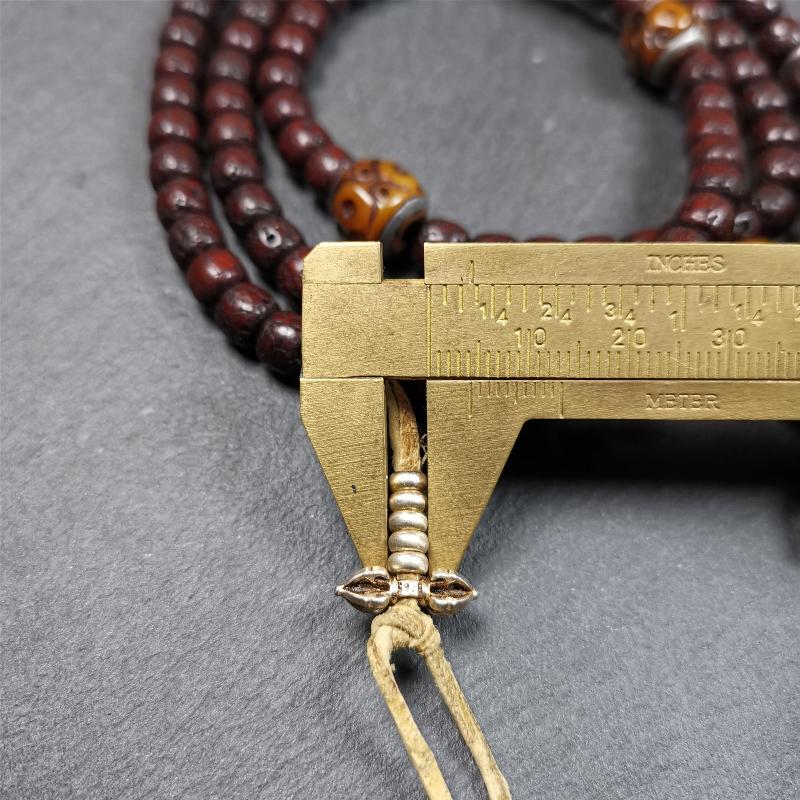 This mala is made by Tibetan craftsmen and come from Hepo Town, Baiyu County,Tibet, the birthplace of the famous Tibetan handicrafts,about 30 years old,blessed by a lama in Baiyu Monastery. It's composed of 108 pcs 8mm lotus seed beads,then add some old bone beads,1 pair of silver bead counters,and silver guru bead,vajra pandent