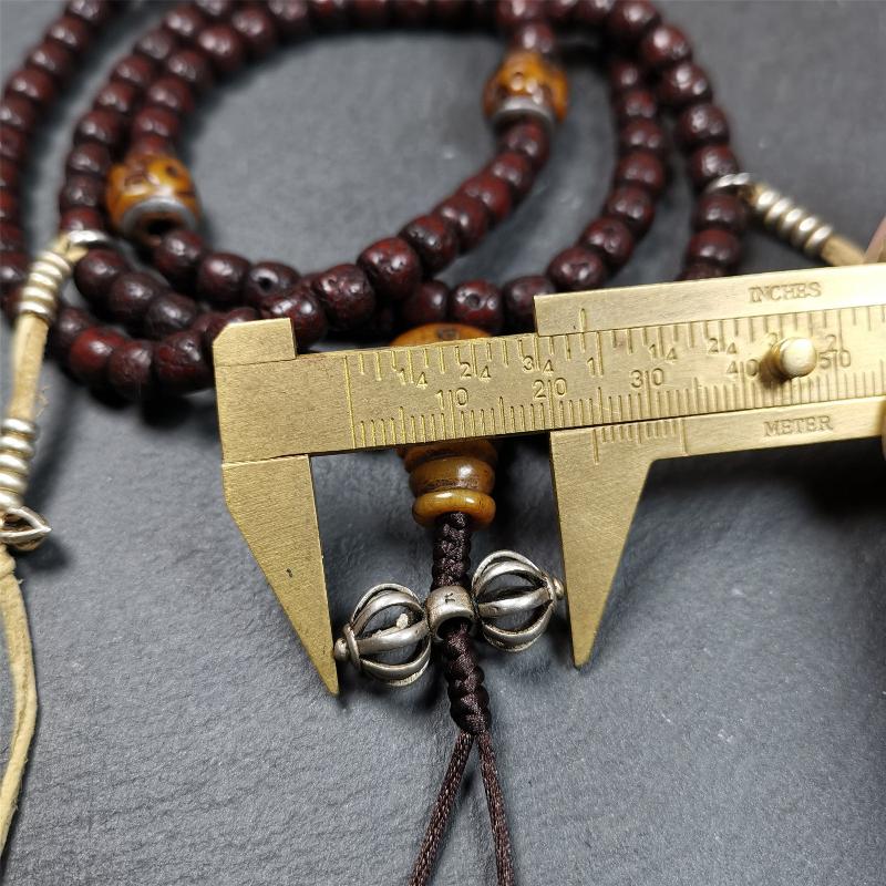 This mala is made by Tibetan craftsmen and come from Hepo Town, Baiyu County,Tibet, the birthplace of the famous Tibetan handicrafts,about 30 years old,blessed by a lama in Baiyu Monastery. It's composed of 108 pcs 8mm lotus seed beads,then add some old bone beads,1 pair of silver bead counters,and silver guru bead,vajra pandent