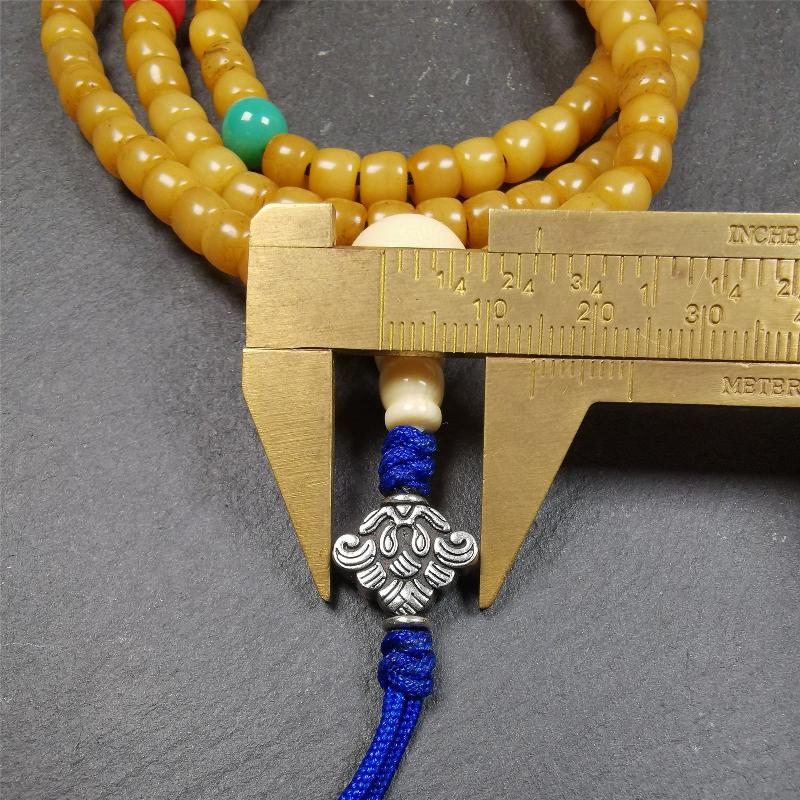 This yak bone mala was handmade from tibetan crafts man in Baiyu County. It's composed of 108 pcs 7mm bone beads,with agate and turquoise beads,guru bead,and mani jewel pendant.