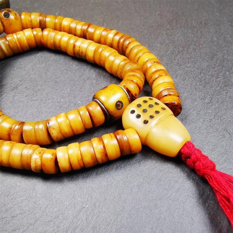 This yak bone mala was handmade from tibetan crafts man in Baiyu County,about 30 years old. It's composed of 108 pcs 9mm bone beads,with bone carved beads,guru bead.