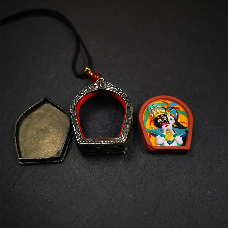 This Drashi Lhamo Gau box is made by Tibetan craftsmen in Hepo Township, Baiyu County,filled in a unique fashion Drashi Lhamo Tsa Tsa - Tibetan girl wearing her mask,made of pottery clay,hand painted.