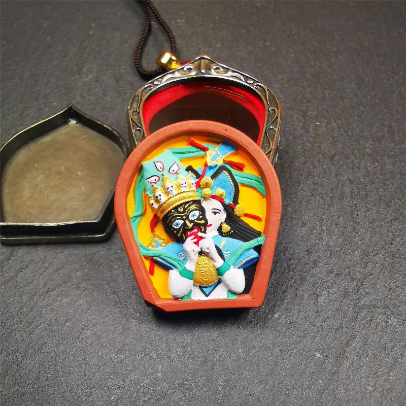 This Drashi Lhamo Gau box is made by Tibetan craftsmen in Hepo Township, Baiyu County,filled in a unique fashion Drashi Lhamo Tsa Tsa - Tibetan girl wearing her mask,made of pottery clay,hand painted.