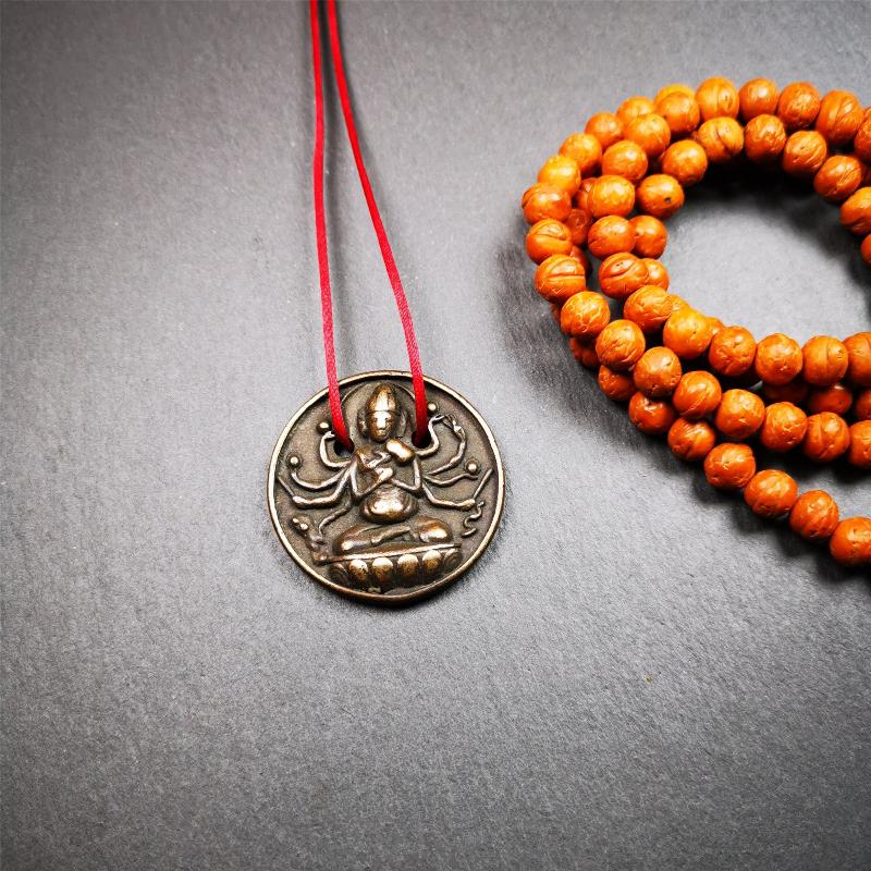 This Usnisa Vijaya statue was collected from Derge,Tibet. It's a badge or pendant,made of copper,brown color, 1.4 inch diameter. You can make it into a necklace,or bag hanging,or just put into your shrine.