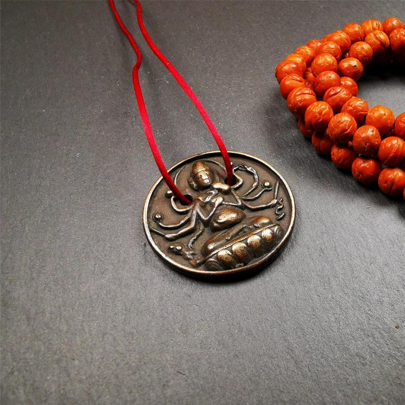 This Usnisa Vijaya statue was collected from Derge,Tibet. It's a badge or pendant,made of copper,brown color, 1.4 inch diameter. You can make it into a necklace,or bag hanging,or just put into your shrine.