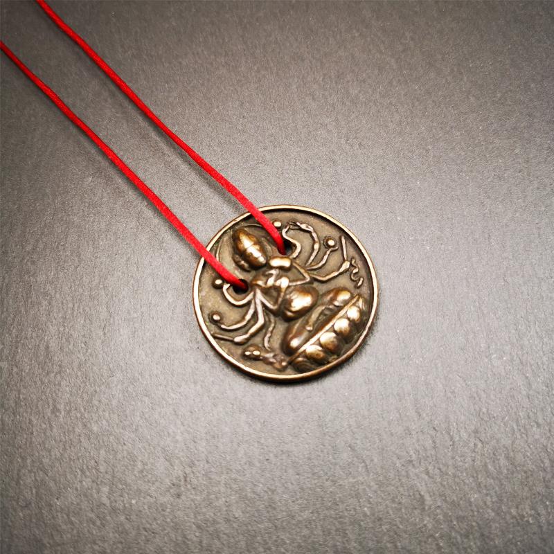 This Usnisa Vijaya statue was collected from Derge,Tibet. It's a badge or pendant,made of copper,brown color, 1.4 inch diameter. You can make it into a necklace,or bag hanging,or just put into your shrine.