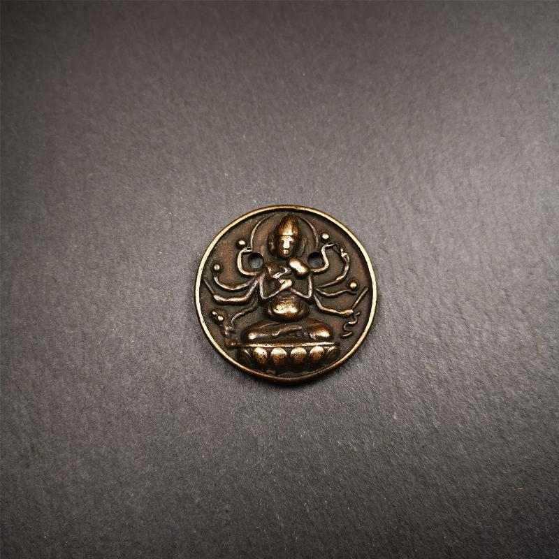 This Usnisa Vijaya statue was collected from Derge,Tibet. It's a badge or pendant,made of copper,brown color, 1.4 inch diameter. You can make it into a necklace,or bag hanging,or just put into your shrine.
