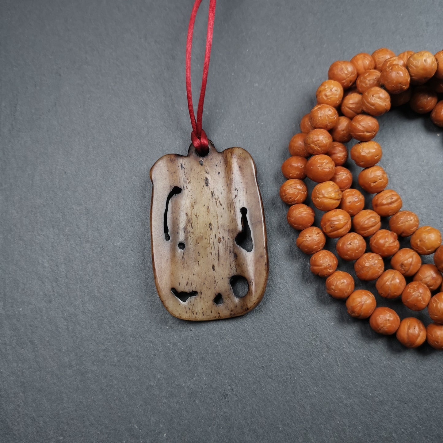 This Troma Nagmo amulet was collected from Gerze Tibet, hand carved by Tibetan Craft man. It is made of yak bone,brown color,size is 2.16" × 1.3". You can make it necklace,or just put into your shrine. Troma Nagmo literally means the Black Wrathful Lady. She is included in the Dharmapala pantheon as a form of Vajravarahi. She is also the feminine embodiment of w