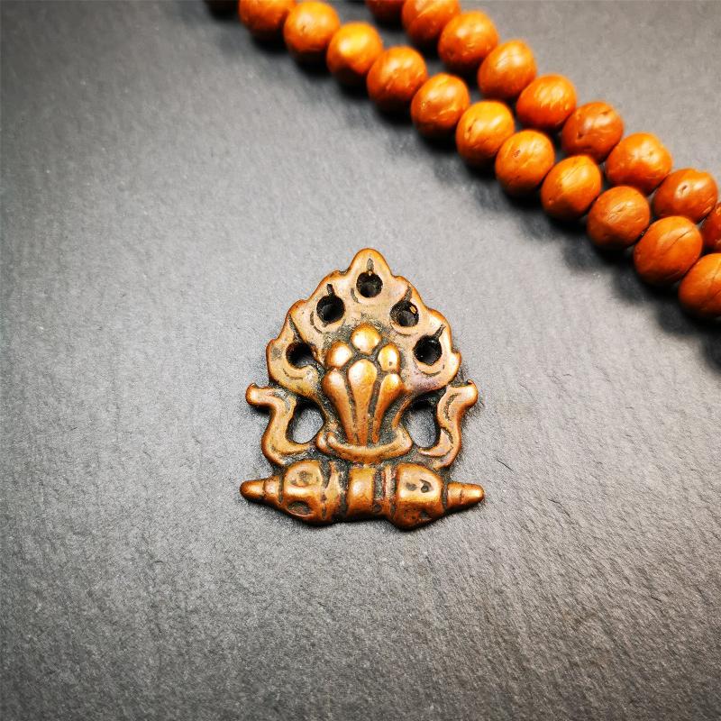This mani jewel amulet was collect from Gengqing Monastery Tibet,it is an old badge or amulet pandent, made of copper, the shape is the mysterious mintamani.